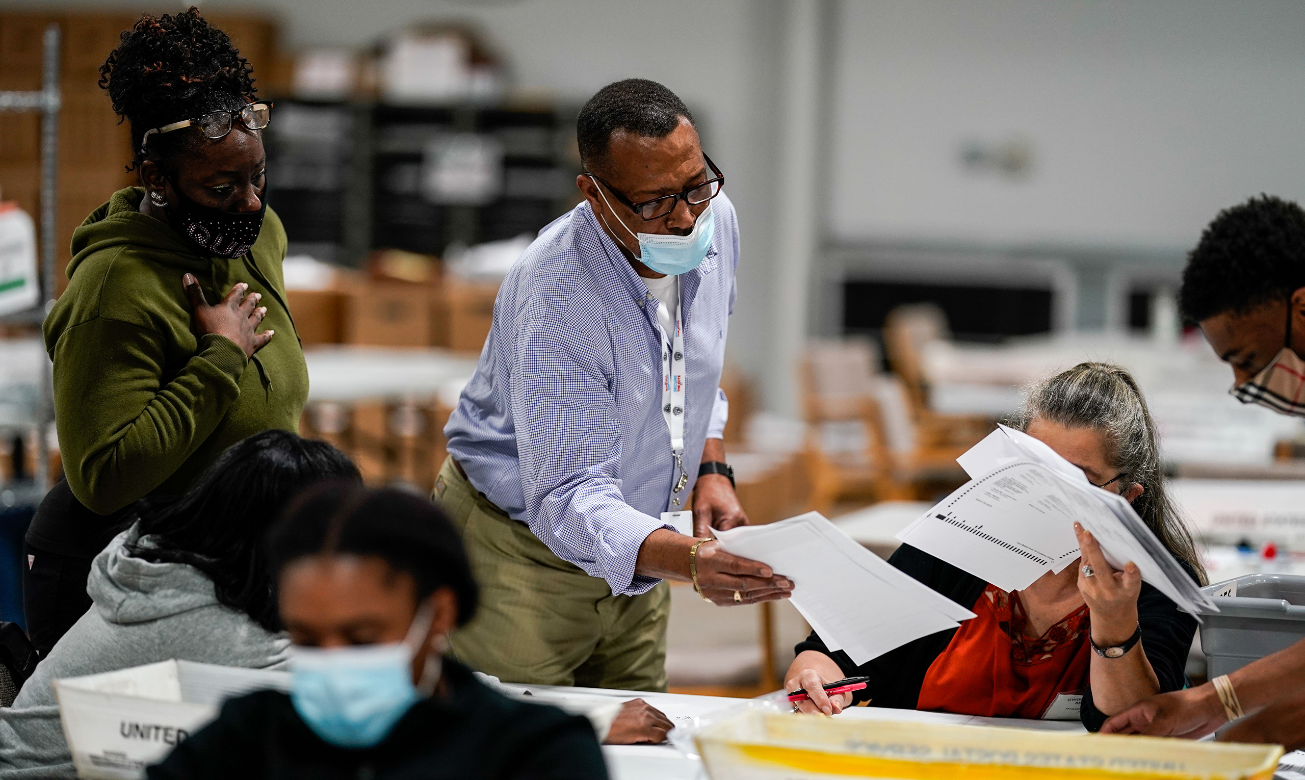 Election workers validate ballots at the Gwinnete County Elections Office on Friday, Nov. 6, 2020 in Lawrenceville, GA.