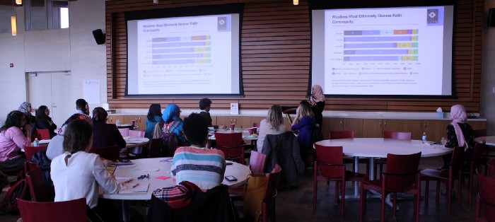 A woman wearing a hijab presents information at an IPSU media training.